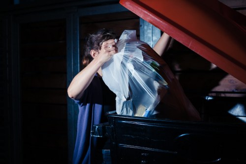 Loading construction debris into a skip in Canary Wharf
